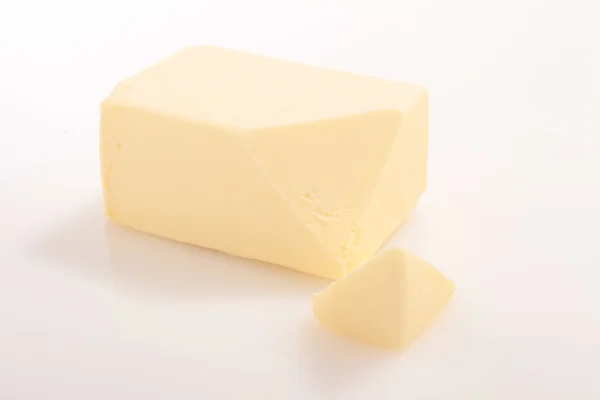 Pat masła w Owinąć folią — Zdjęcie stockowe