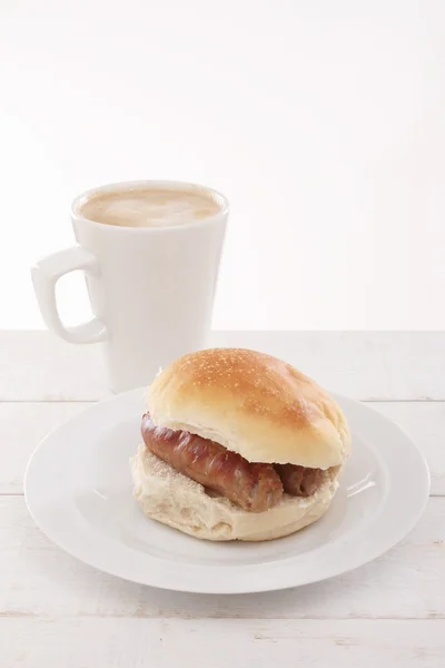 Plated sausage sandwich with cappuccino — Stock Photo, Image