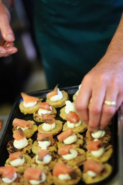 Chef faisant des canapés avec du saumon fumé — Photo