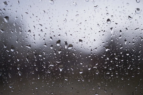 Water drops on the window in rainy day — Stock Photo, Image