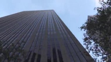 Driving pass modern glassy sky high skyscrapers in big city