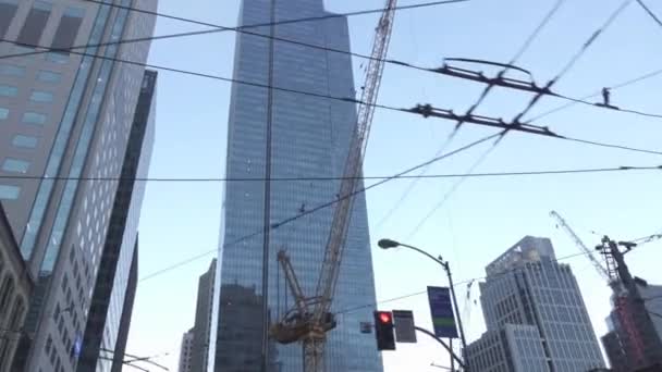 Driving through modern city construction site with skyscraper cranes — Stock Video