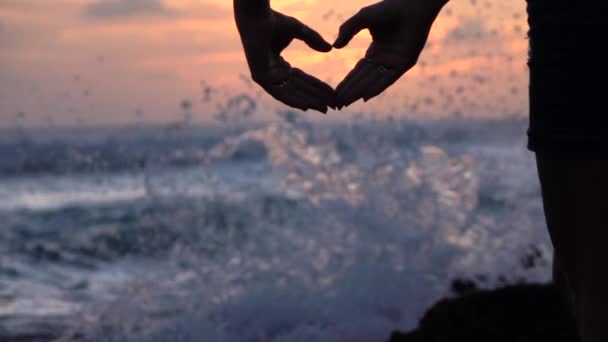 SLOW MOTION: Giovane ragazza forma il cuore con le mani sopra il bel cielo serale — Video Stock