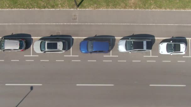 AERIAL: Önvezető jármű egy üres közúti parkolóhelyre parkol. — Stock videók