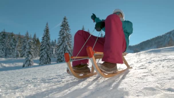 閉じる:陽気女性観光客は晴れた日に雪の丘をそります. — ストック動画