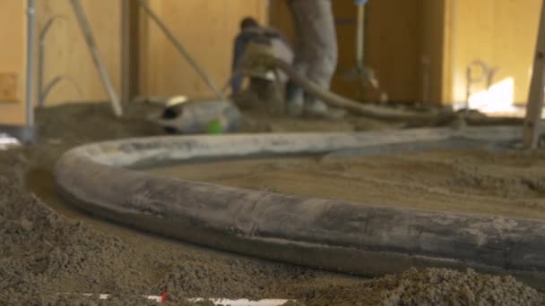 FECHAR UP: Mangueira de borracha pulsa como empreiteiros derramar concreto em todo o solo. — Vídeo de Stock