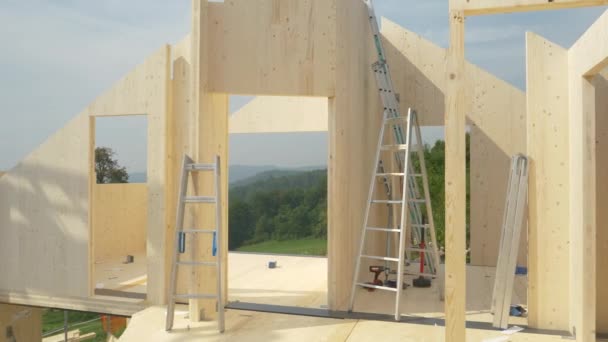 CLOSE UP: Ladders are scattered around the top floor of an unfinished CLT house. — Stock Video