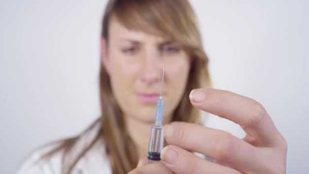 FECHAR: Mulher que trabalha no local de vacinação prepara uma seringa com vacina. — Vídeo de Stock