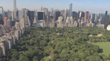 AERIAL: Flying over Central Park and the towering skyscrapers of New York City.