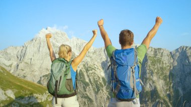 CLOSE UP: Excited trekkers celebrate reaching the summit in stunning Alps.