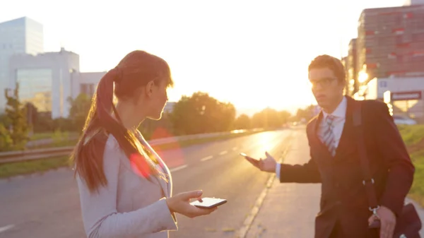 LENS FLARE: Businessman and woman are annoyed with each other after crashing. — стоковое фото