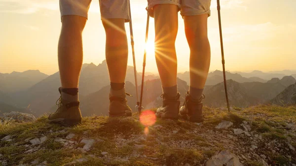 SUN FLARE: Active man and woman in hiking boots walk up to the mountain peak. — Φωτογραφία Αρχείου