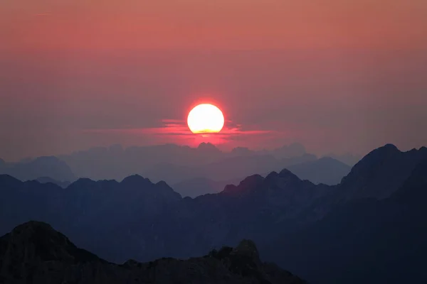 AERIAL: Stunning shot of colorful evening sky above the untouched Julian Alps. — Stock Photo, Image