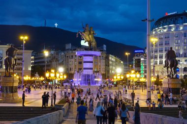 DRONE: Flying over a stone bridge leading to the busy central square in Skopje.