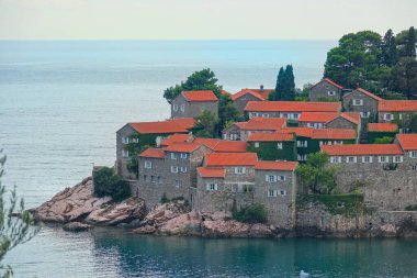 DRONE: Calm Adriatic sea surrounds the beautiful historic island in Montenegro.