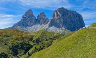 DRONE: Flying above empty meadows below the scenic mountain road in Dolomites.