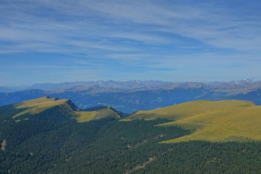 AERIAL: Flying high above the untouched forest and meadows in the Dolomites.