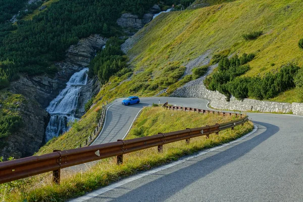 Light corridas de carro azul através de um grampo de cabelo virar correndo passado fluxo de montanha vítrea. — Fotografia de Stock