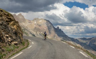 Active male tourist enjoys a scenic bicycle trip along the great alpine route.