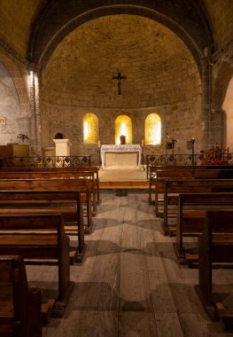 VERTICAL: Beautiful shot of an altar and benches inside an empty Catholic church