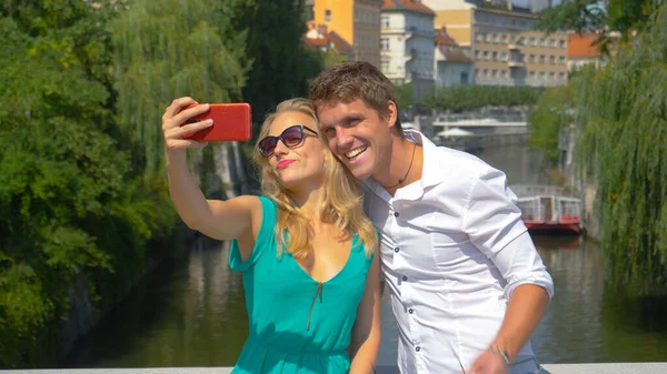 CLOSE UP: Traveler couple films a video blog while exploring the scenic old town — Photo