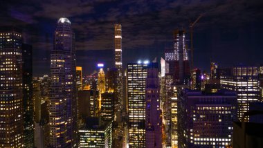 Geceleri New York 'un sayısız gökdelenlerinin nefes kesici manzarası parlıyordu.