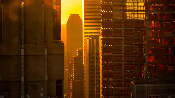 ZAMKNIJ SIĘ: Piękny zachód słońca odbija się od szklanego wieżowca w Nowym Jorku. — Zdjęcie stockowe