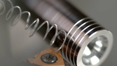 Keskin kesici iplik boyunca küçük metal bir çubuğa bir iplik oyuyor.