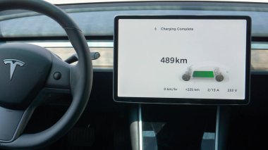 Tesla arabasının içindeki dokunmatik pedde şarjın tamamlanmış olduğu görülüyor..
