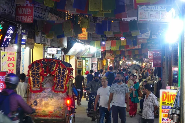 LOSE UP: Stadstrafiken rör sig längs de färgglada souvenirbutikerna i Katmandu. — Stockfoto