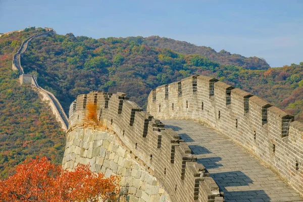 Scenic view of the cobblestone path on top of the Great Wall at golden sunset.