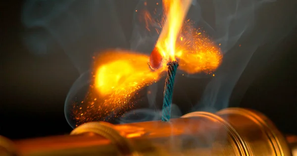 MACRO, DOF: Burning match lights up the short fuse of a vintage brass cannon. — Stock Photo, Image