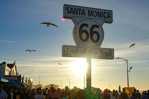 CLOSE UP: Tourists gather at the end of Route 66 on a sunny spring evening. — Stock Photo, Image