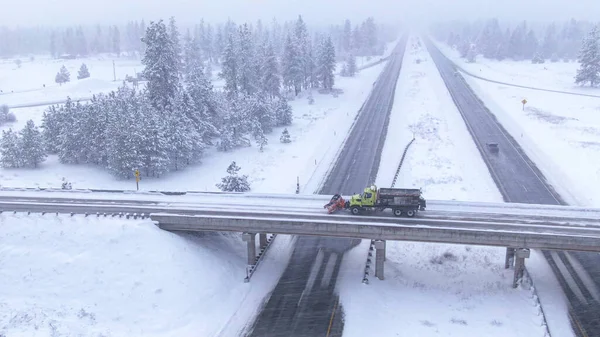 DRONE Truck plows a road crossing the interstate highway in wintry United States — Stock Photo, Image