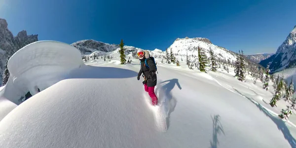 SELFIE: Cool snowboarder girl shreds fresh powder in mountains of Bella Coola. — Photo