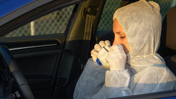 CLOSE UP: Virologist puts on her facemask before driving to covid19 epicenter.