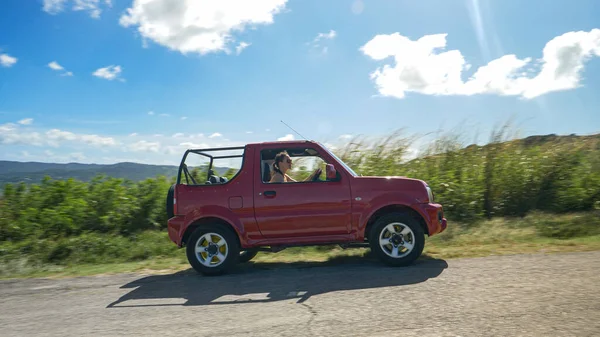 Vrolijke toerist in een rode jeep rijdt rond Barbados en verkent het eiland. — Stockfoto