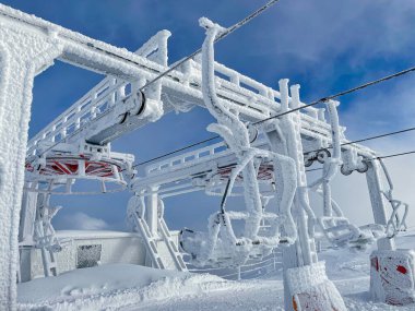 Boş teleferik istasyonu ve banklar kalın bir buz tabakasıyla kaplı..