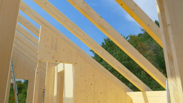 Uncovered roof of a modern cross laminated timber house reveals the clear sky. — Stock Photo, Image