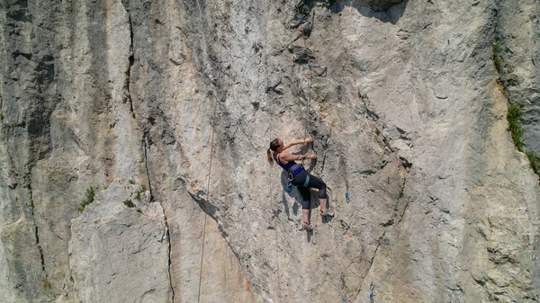 AERIAL: Drone point of view of an athletic woman learning to top rope climb. — Stock Photo, Image