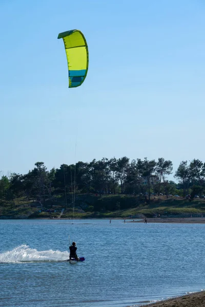 VERTICAL: Athletic male is kitesurfing in the scenic Adriatic seaside in Croatia — Foto de Stock