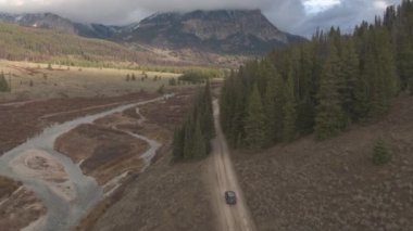 Jackson, Wyoming 'de toprak yolda bir turist arabasının arkasında uçmak..