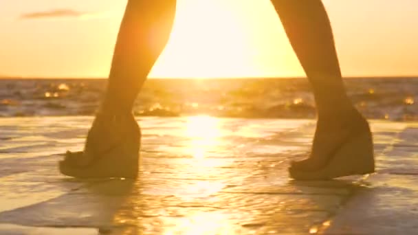 LOW ANGLE: Young woman in high heels walks along the scenic stone promenade. — Stock Video