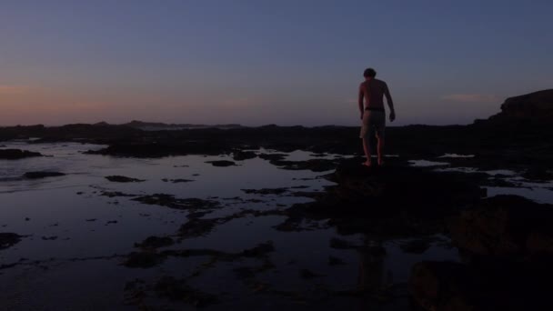 男人在日出时走进海洋 — 图库视频影像