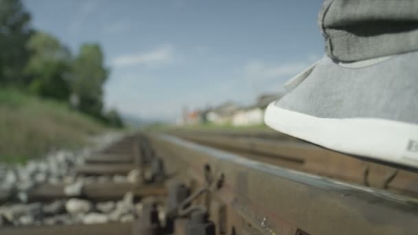 Man walking on railroad track — Stock Video