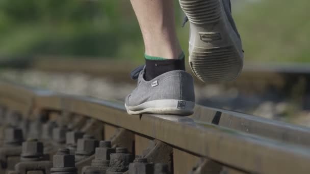 Man walking on railroad track — Stock Video