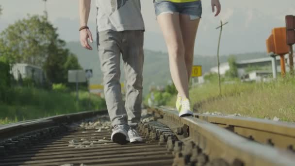 Couple walking on railroad tracks — Stock Video