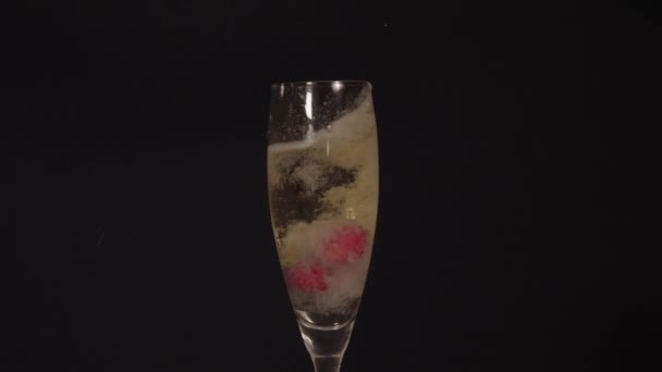 Strawberries falling into the champagne — Stock Video