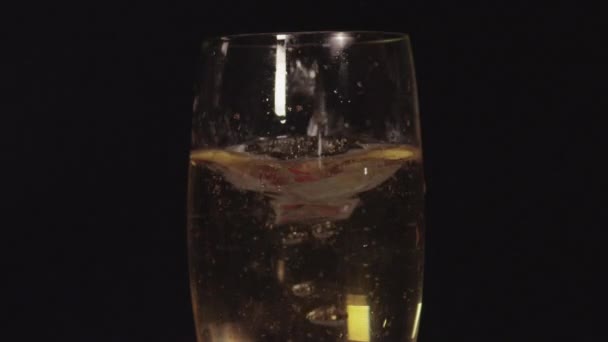 Strawberries falling into the champagne — Stock Video