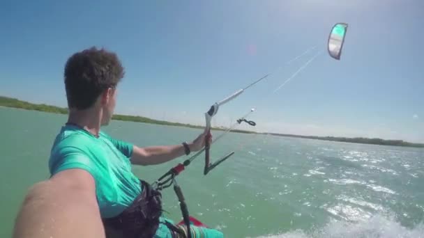 Kiter kiteboarding in zonnige flat lagune — Stockvideo